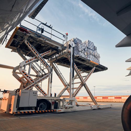 Preparation before flight. Loading of cargo containers to airplane at airport.; Shutterstock ID 1797435868; other: -; purchase_order: -; client: -; job: -