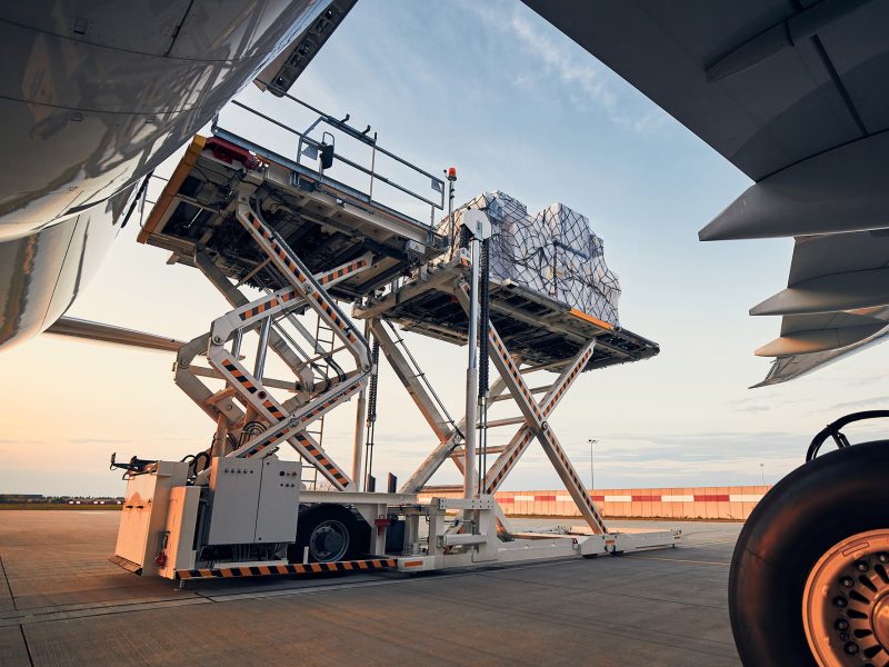 Preparation before flight. Loading of cargo containers to airplane at airport.; Shutterstock ID 1797435868; other: -; purchase_order: -; client: -; job: -